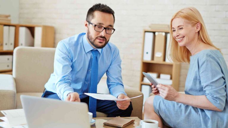 Two professionals discussing healthcare benefits and savings with Aetna Health Savings Account (HSA) for smart medical expense planning.
