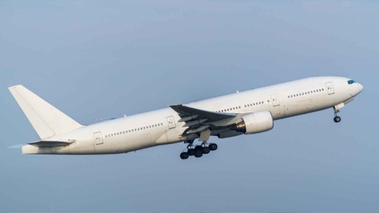 B777 Emirates Business Class aircraft taking off, offering luxury travel with premium seating, fine dining, and award-winning service.