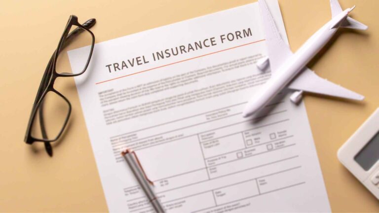 Travel insurance form with glasses and airplane model representing Direct Line travel insurance coverage.