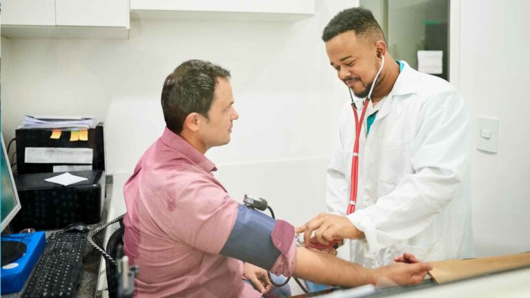 Doctor checking patient’s blood pressure at Atrius Health Easton MA clinic
