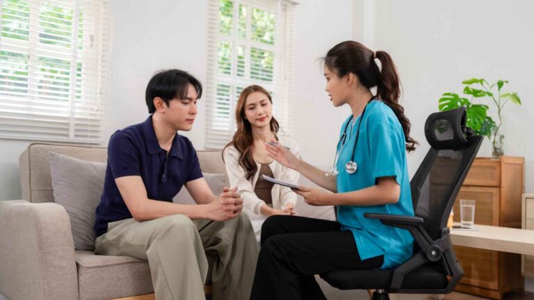 Doctor consulting a couple at Atrius Health Wellesley MA for personalized family healthcare services
