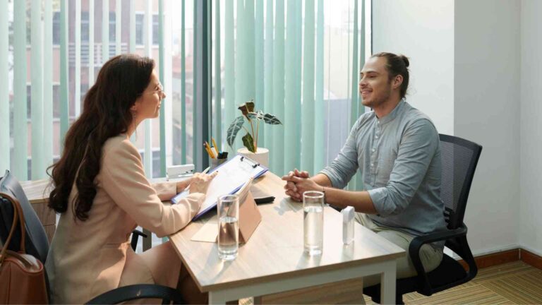 A professional interview discussing advancements in cardiac technology in a modern office setting.