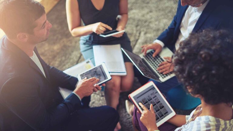 Team discussing strategy on digital devices – a practical business case example