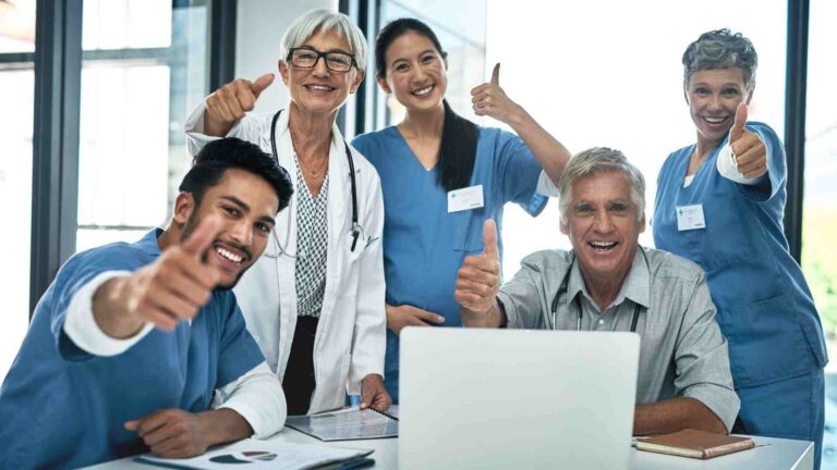 Atrius Health Concord medical team smiling and giving thumbs up for patient care success