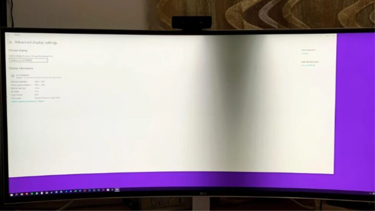 A curved LG monitor showing computer screen shadow problem on Windows 10 display settings.