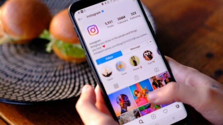 A person scrolling through the Instagram profile page on a smartphone, representing how to buy Instagram followers the smart way for real engagement.